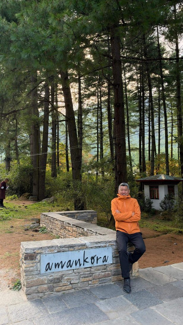 Man in orange jacket outdoors.
