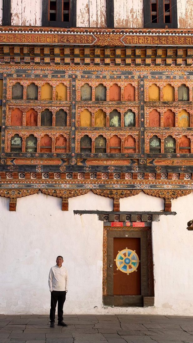 Man and ornate building wall