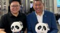 People holding panda plush toys