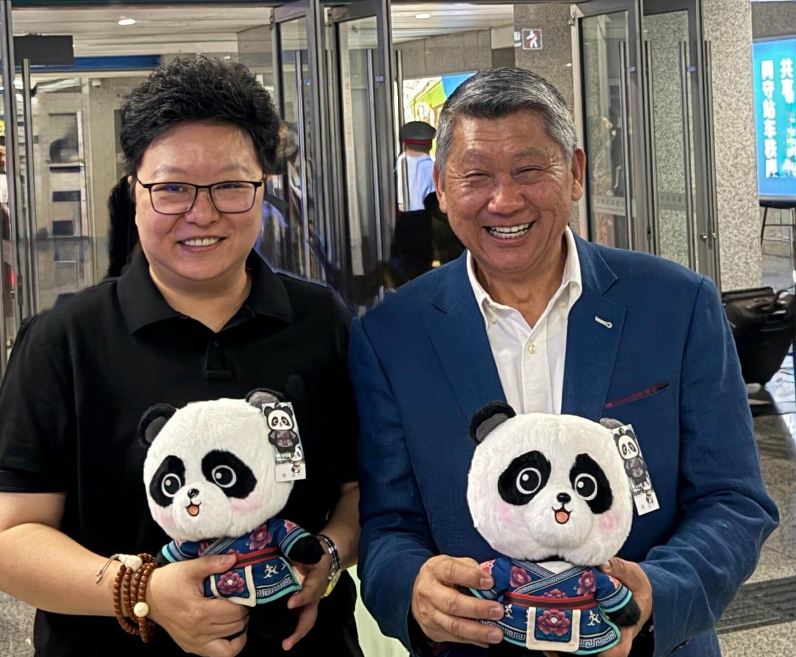 People holding panda plush toys
