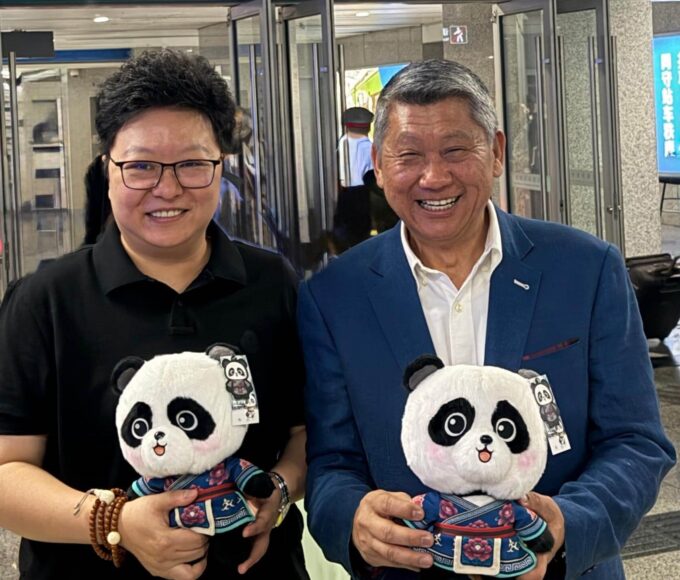 People holding panda plush toys