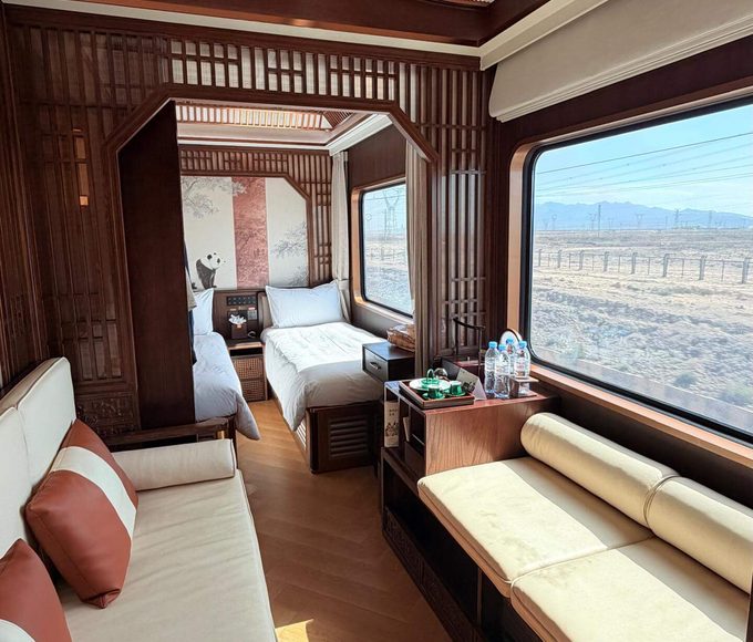 Luxury train cabin with beds.